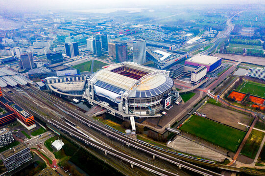 Aerial drone view of Johan Cruyff Arena, AFC Ajax stadium, Amsterdam Zuidoost and Amsterdam city skyline, Netherlands