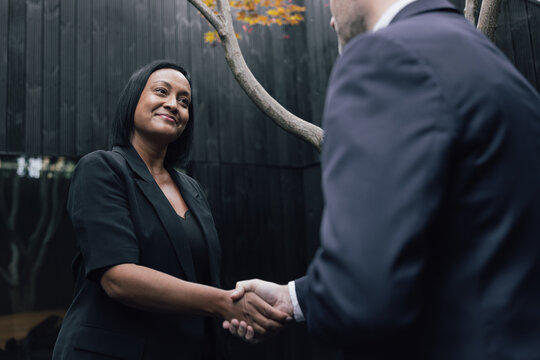 Executive handshake outdoors in a modern city setting