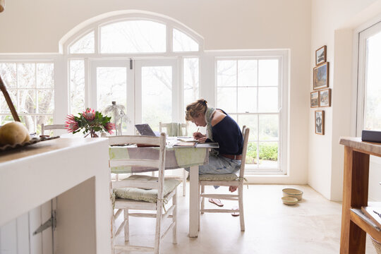 20 year old woman artist working on a drawing in her studio