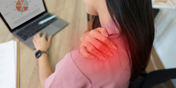 Cropped view of Asian woman's shoulder with red highlight indicating pain for ergonomics and healthcare discomfort
