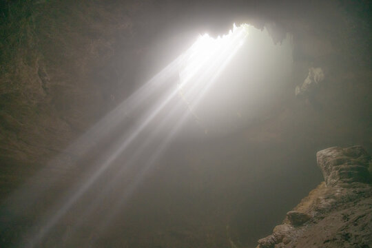 Sun ray falling into Jomblang Cave, Central Java, Indonesia.