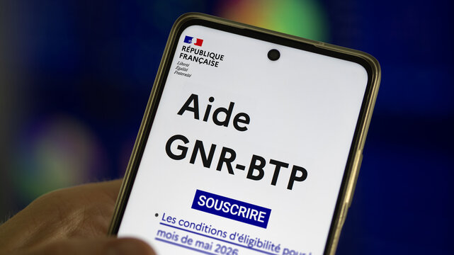 Aide GNR-BTP Close-up of a smartphone screen displaying the French government website for the "Aide GNR-BTP" financial support program, "R&eacute;publique Fran&ccedil;aise" logo.