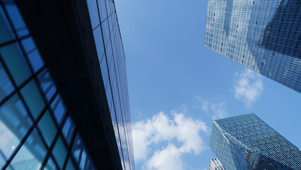 Fototapeta premium Modern Glass Building Facade Under Clear Blue Sky