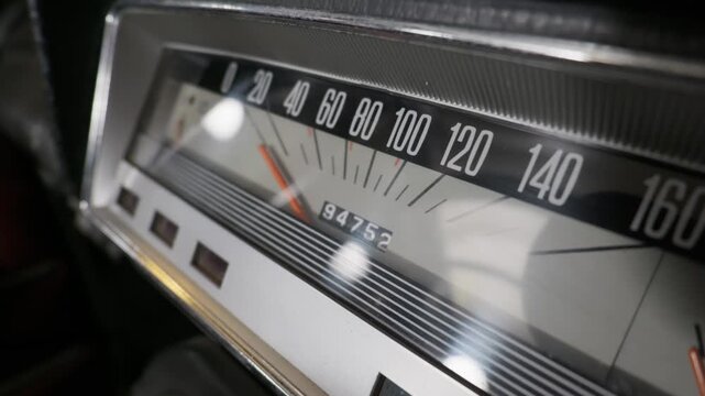 Close-up view of a vintage analog car speedometer and odometer showing travel mileage and speed. Concept of classic car restoration, nostalgic road trips, and retro automotive design.
