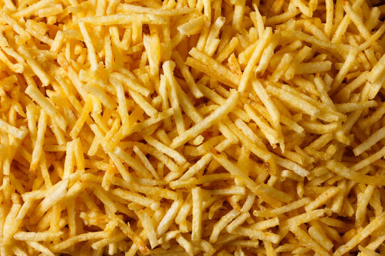 Background image with crispy fried potato sticks. A traditional Brazilian food