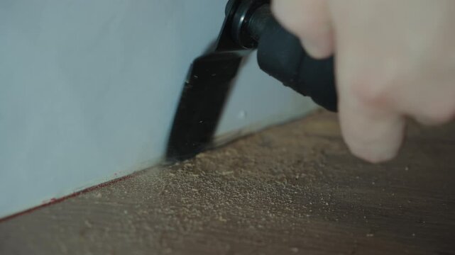 Oscillating Multi Tool Cutting Along Wall Base