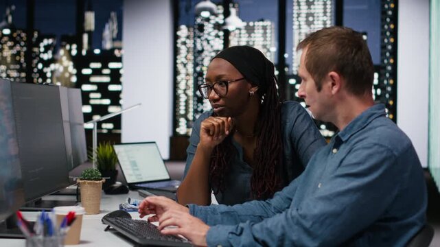 Engineering team in office working to fix bugs in AI systems using computer with debugging and troubleshooting context for AI development workflow.