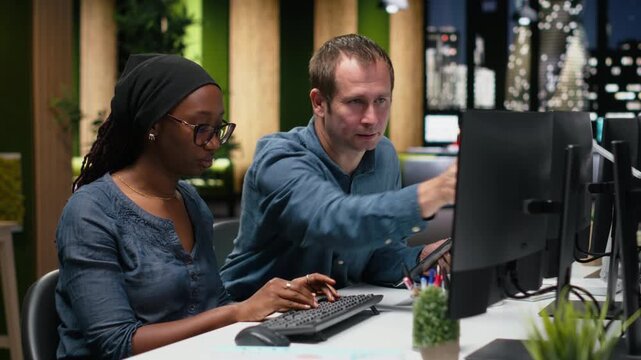 Engineering team typing complex code on computer, developing machine learning models to automate business tasks in workspace. Teamworking colleagues write programming language scripts on PC.