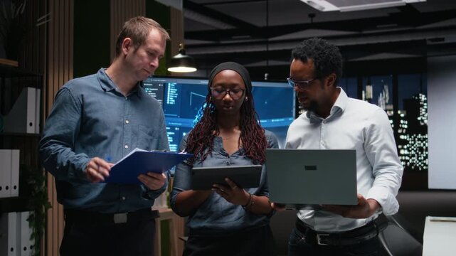 Portrait of engineering team developing AI algorithms in high rise office. Teamworking colleagues debug 3D neural network brain models shown on screen.