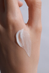 Fototapeta premium female hand with a cream swatch on it, cream on a hand