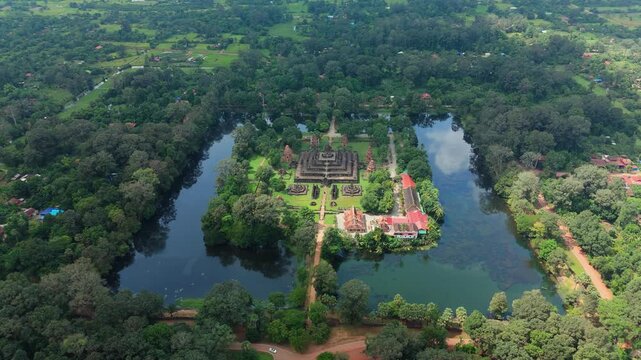 Drone orbits right over Bakong Temple, showing the moat, central sanctuary, forest, and grounds in Siem Reap