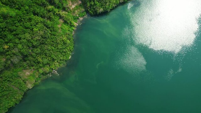 Static atmospheric aerial frame of Mt Maculot and Labangan Bay green clean water in Cuenca Batangas Philippines during bright daylight.