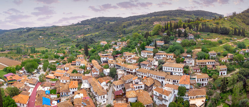 Sirince, Turkiye, hillside village view featuring traditional white houses, red tile roofs, and scenic green landscape
