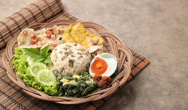 Nasi Megono, a signature dish from Central Java, Indonesia, featuring steamed rice topped with finely chopped young jackfruit mixed with grated coconut and aromatic spices