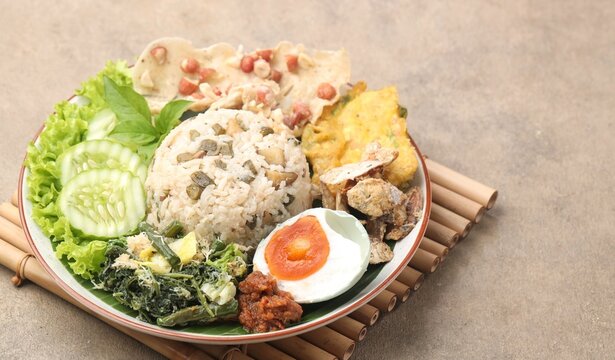 Nasi Megono, a signature dish from Central Java, Indonesia, featuring steamed rice topped with finely chopped young jackfruit mixed with grated coconut and aromatic spices