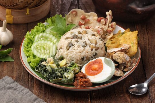 Nasi Megono, a signature dish from Central Java, Indonesia, featuring steamed rice topped with finely chopped young jackfruit mixed with grated coconut and aromatic spices