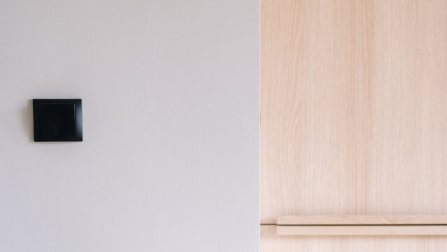 Black light switch on white wall in contemporary apartment