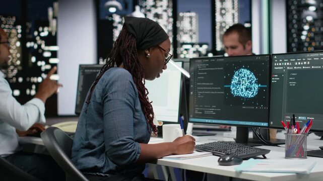 Technician writing down automation ideas on paper to streamline repetitive tasks using AI scripts for coding and software work.