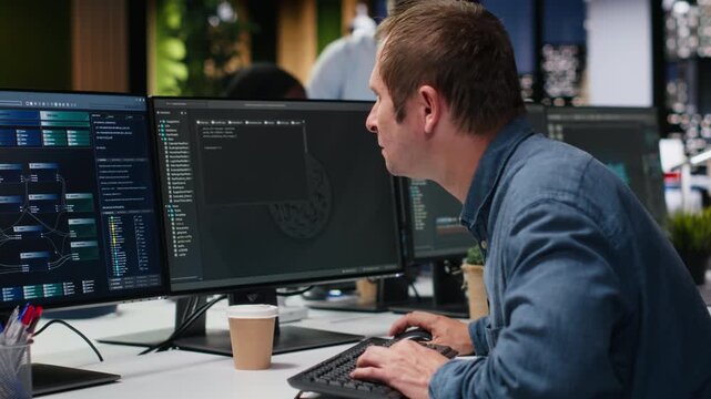 Software developer in office typing code on computer, developing machine learning models to automate tasks. Tech startup IT expert write programming language scripts on PC for coding workflows.