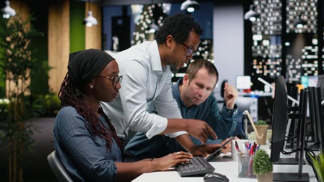 Engineering team brainstorming in office, typing code on computer, developing machine learning models to automate tasks with teamwork and productivity context.