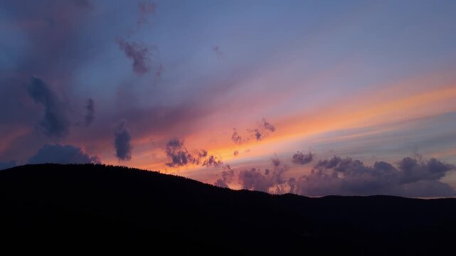 Aerial Video of Fiery Colorful Dawn Sky Over Dark Forest Silhouette