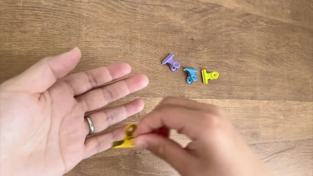 Child Hand Choosing a Yellow Clip and Giving It to Mom, 4K Silent Video