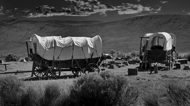 Simulated black and white, old movie style of wagons on the Oregon trail, USA