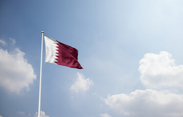 Fototapeta premium Qatar flag waving in sky with long mast.