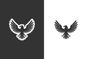 Fototapeta premium A stylized silhouette of an eagle with spread wings, presented on both black and white backgrounds