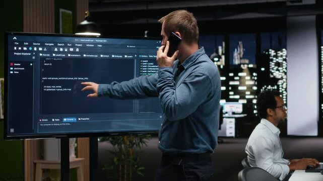 Silicon Valley company manager office making phone call, developing apps. Team leader calling employees to debug applications and resolve issues, supervising progress for coding workflows.