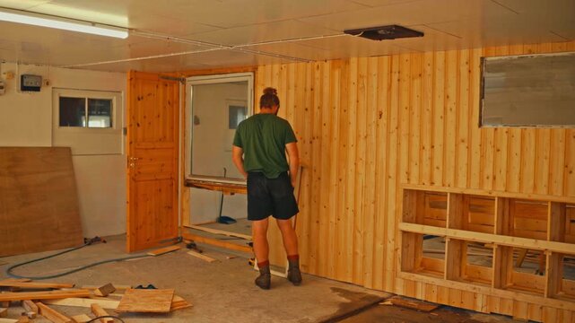 Man Renovating A Room With Groove Paneling - Timelapse