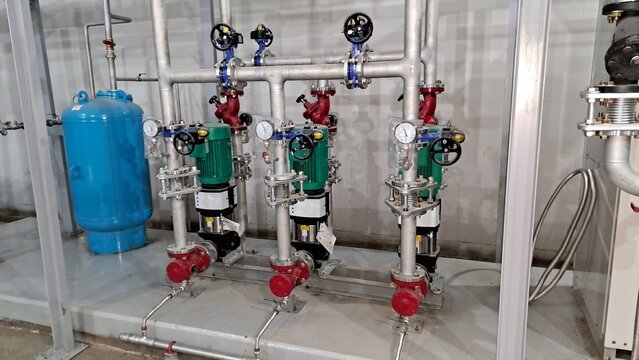 industrial booster pump system and pressure tank installed in a mechanical equipment room