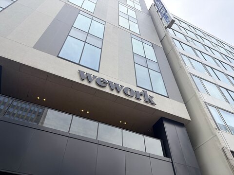 WeWork coworking space signage on a modern corporate office building facade with glass windows and contemporary architectural design in Sapporo - Hokkaido, Japan, May 10, 2026