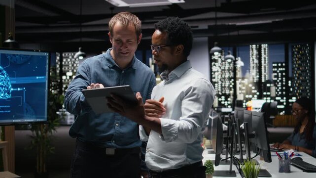 Engineers developing artificial intelligence algorithms in modern high rise office. IT experts debug applications while visualizing 3D neural network brain models on glowing screens.