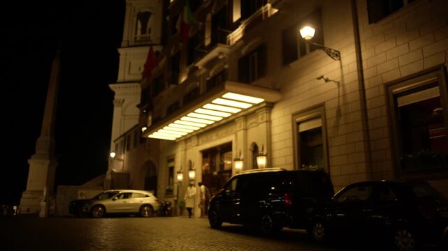 Historic Hotel Entrance and Illuminated Streetscape at Night in Rome Italy Urban Travel Scene Shot with Cinema Camera