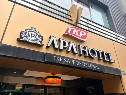 APA Hotel TKP Sapporo Ekimae exterior signage and building facade featuring prominent hospitality branding and corporate logos in the city center - Hokkaido, Japan, May 10, 2026