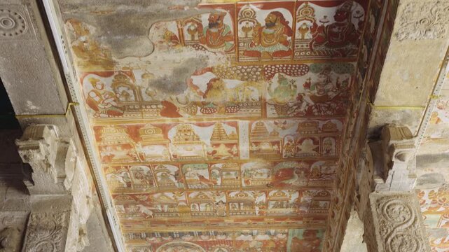 Ancient temple ceiling paintings with intricate murals, vibrant traditional artwork, and carved stone pillars. Historic Indian heritage architecture showcasing preserved cultural art and craftsmanship
