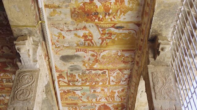 Ancient temple ceiling paintings with intricate murals, vibrant traditional artwork, and carved stone pillars. Historic Indian heritage architecture showcasing preserved cultural art and craftsmanship