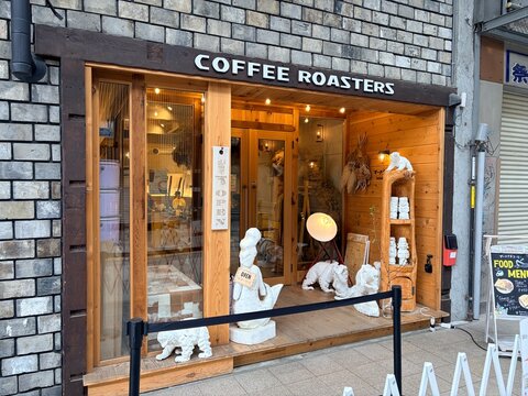 Saito Inkan (Saito Seal Shop) store facade featuring modern wooden architecture and artistic white sculptures near a coffee roasters cafe in Sapporo city - Hokkaido, Japan, May 10, 2026
