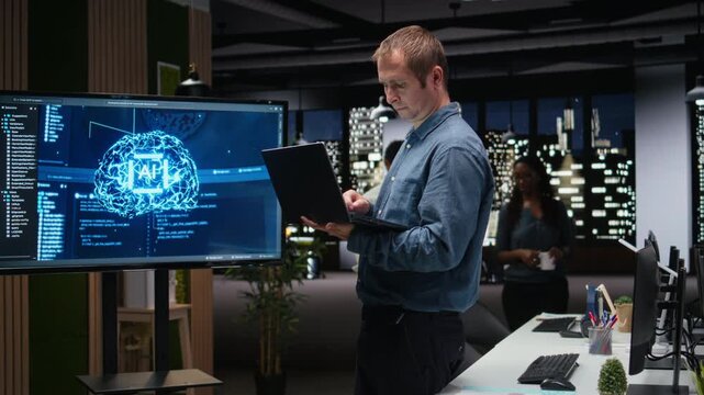 Software developer in office using laptop, working to fix bugs in AI system with debugging and troubleshooting context for AI development workflow.