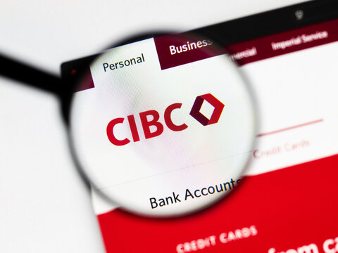 Milan, Italy 2026, 20 Apr Closeup of CIBC Canadian Imperial Bank website on a laptop screen. CIBC Canadian Imperial Bank logo under a magnifying glass.