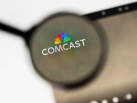 Milan, Italy 2026, 20 Apr Closeup of Comcast website on a laptop screen. Comcast logo under a magnifying glass.