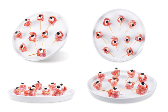 Mozzarella sausage olive canape in the form of eye in a plate on a white isolated background
