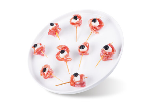 Mozzarella sausage olive canape in the form of eye in a plate on a white isolated background