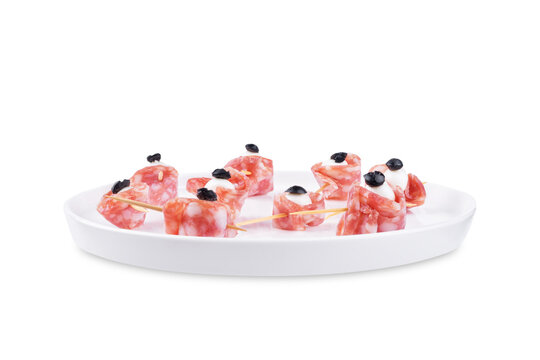 Mozzarella sausage olive canape in the form of eye in a plate on a white isolated background