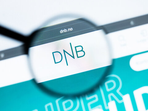 Milan, Italy 2026, 20 Apr Closeup of DNB Bank website on a laptop screen. DNB Bank logo under a magnifying glass.