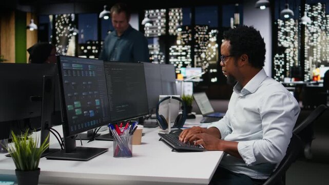 Engineer in Silicon Valley company office developing apps with AI. IT professional using machine learning to do coding, debugging applications to resolve issues for coding workflows.