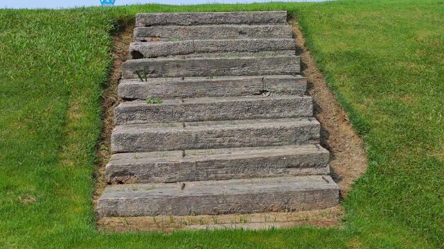 The stairs are made of concrete slabs , on the golf course
