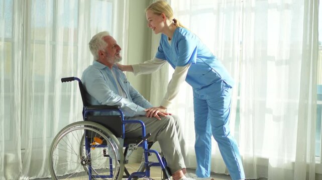 Help support retirement healthcare. Nurse helping old man in wheelchair. Patient and woman in nursing home for medical caregiver. Nurse taking care of paralyzed man in chair for people with disability