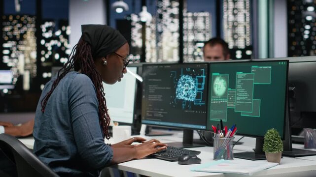 Panicked female engineer in office requests help from colleagues to block hacker intrusion with teamwork context.